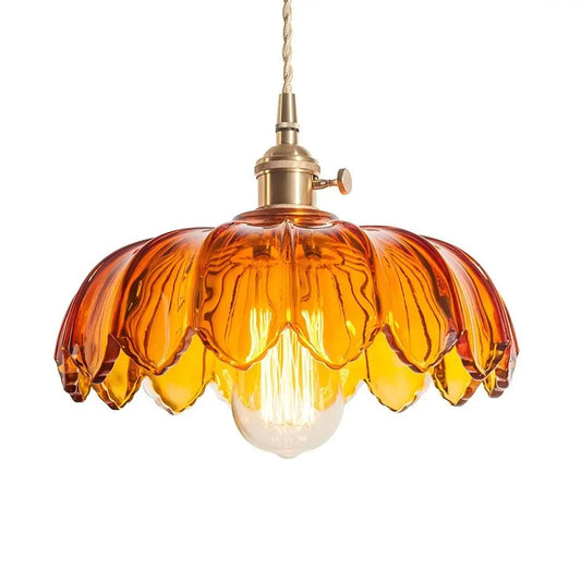 A detailed shot of an amber fluted glass pendant lamp, highlighting its warm glow and elegant brass ceiling fixture.