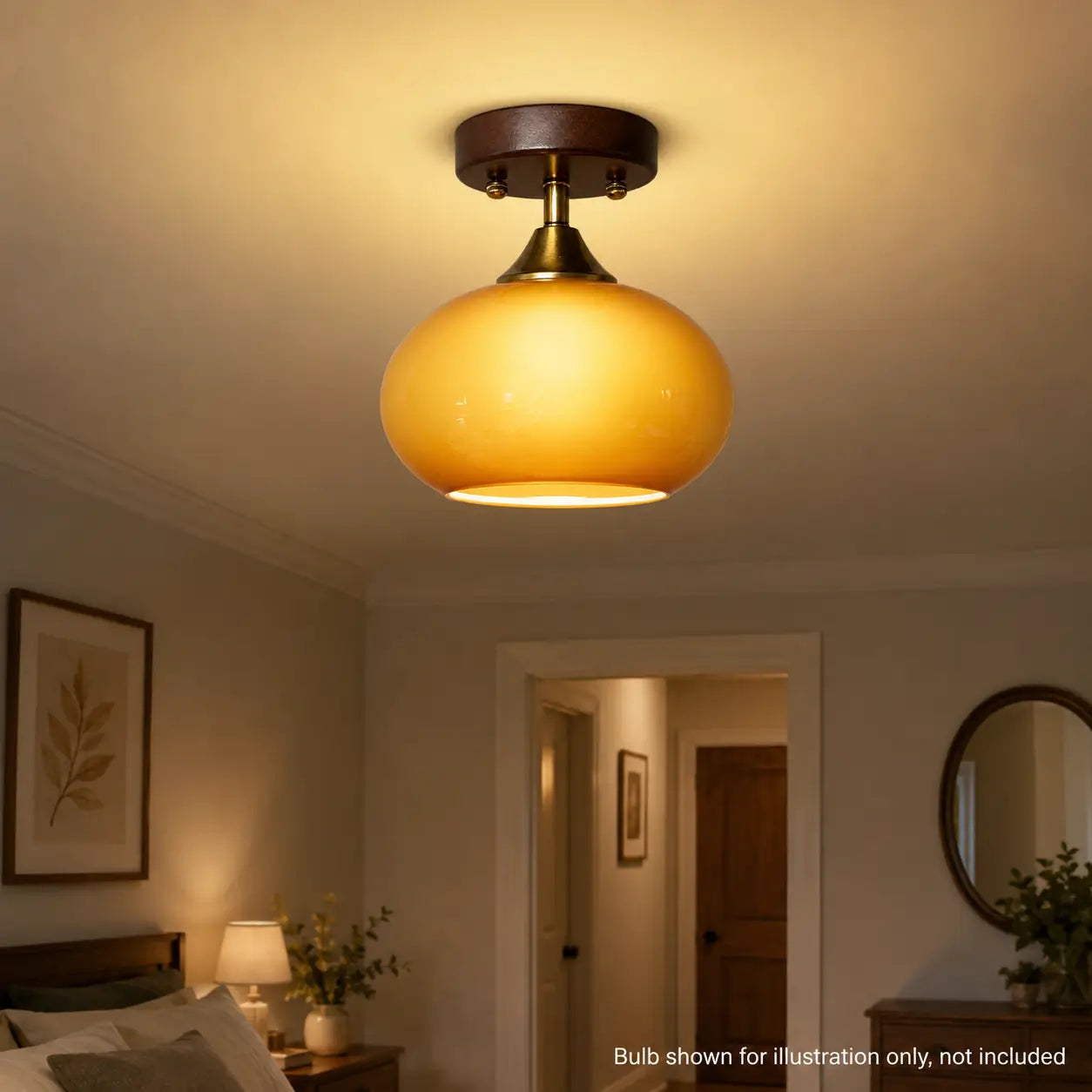 Amber glass ceiling light illuminated above a bedroom doorway at night