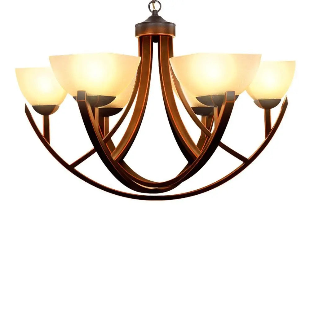 Antique bronze chandelier with curved arms and warm frosted glass shades.
