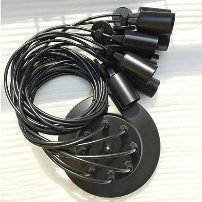 A black cable light fixture kit laid out, displaying the central black mounting plate, multiple black lamp holders, and coiled black electrical cables, representing the components of a DIY spider chandelier.