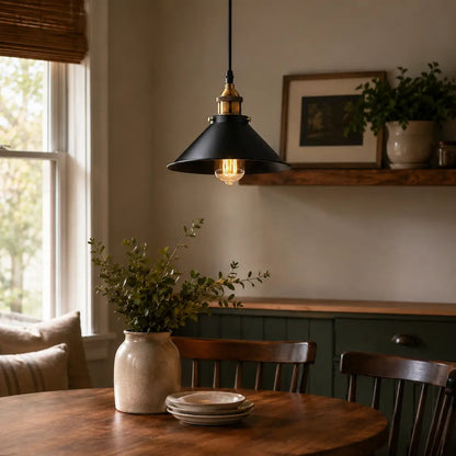 Black cone pendant light over a warm dining area with wood table, window light, and classic decor