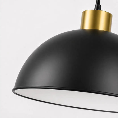 Close-up of the 30 cm matte black dome shade with white interior, black rim, and warm gold-tone top accent.