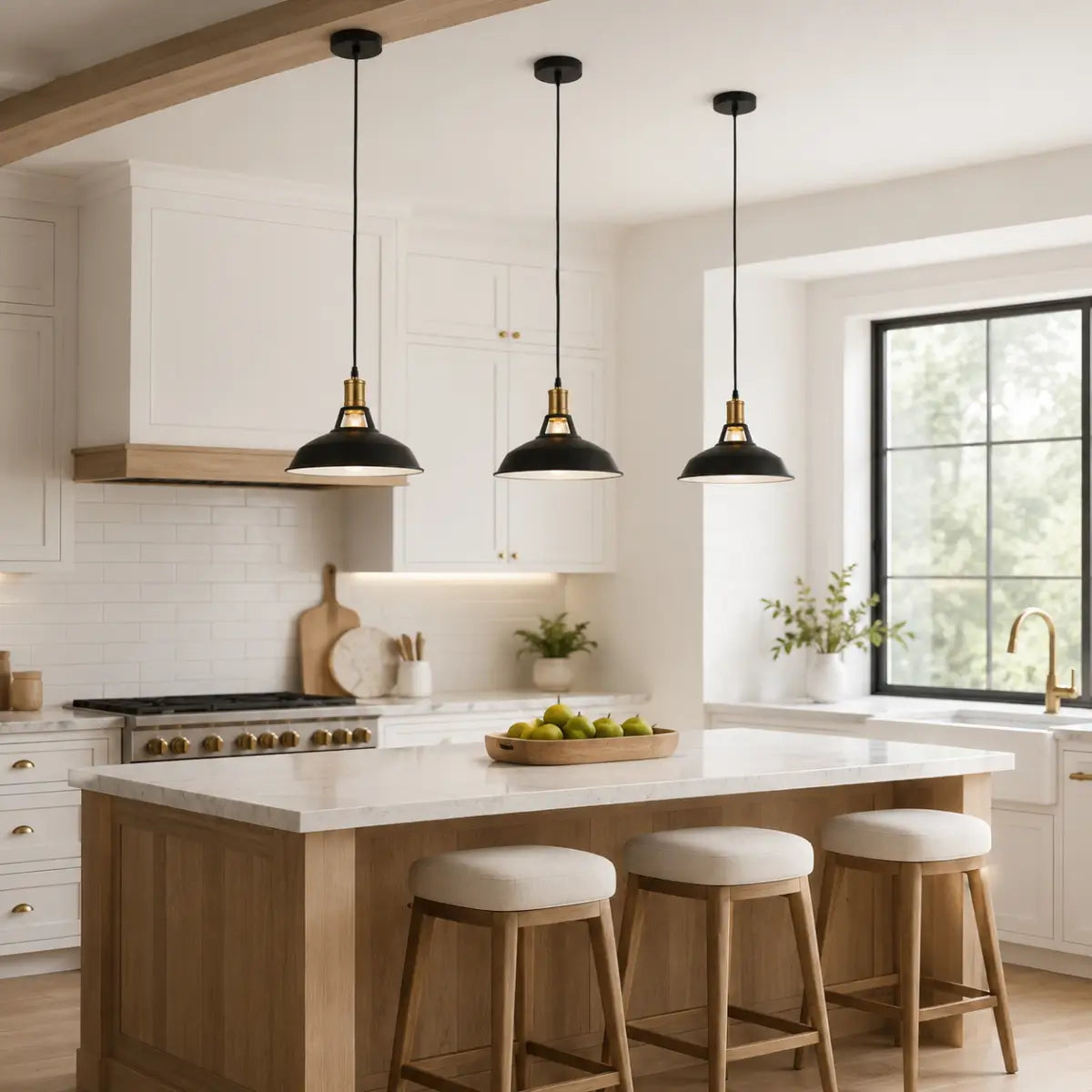 Three black dome pendant lights installed above a wood and white kitchen island.