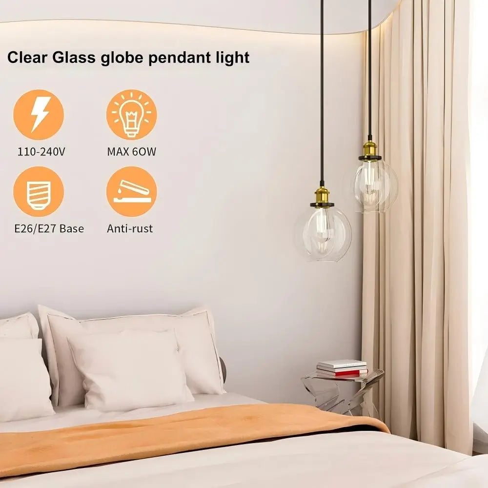 Two clear glass globe pendant lights hanging above a bed in a modern bedroom, highlighting features like E26/E27 base and anti-rust finish.