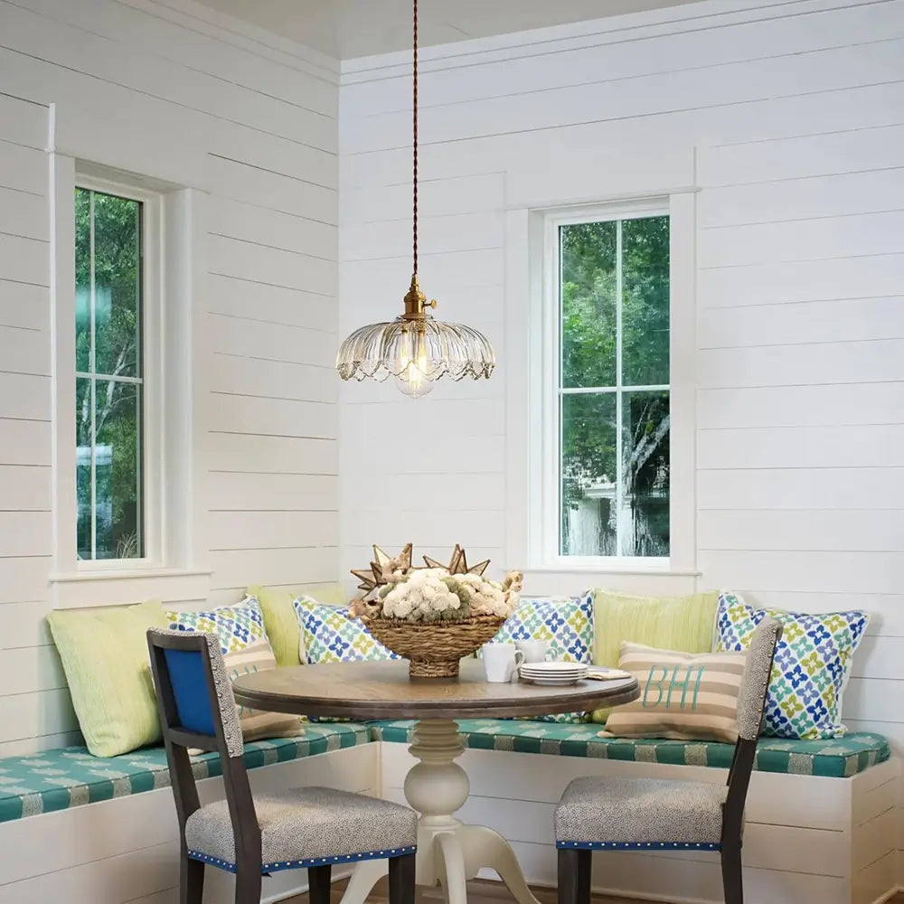 A clear glass pendant light hanging in a modern kitchen, serving as a stylish accent over a counter.