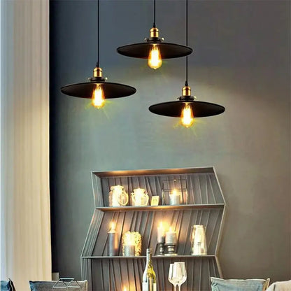 Three decorative black pendant lights with exposed Edison bulbs creating ambient lighting in a living room or dining area.