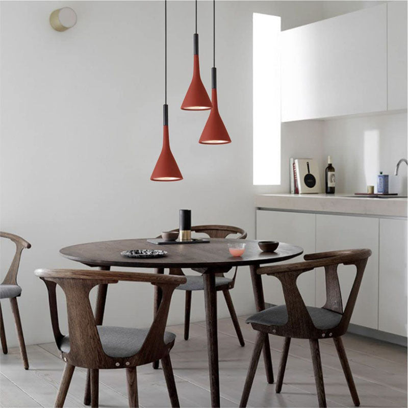 red pendant lighting over dining table