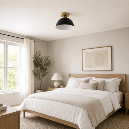 Black dome semi-flush mount ceiling light installed above a bed in a neutral-toned bedroom