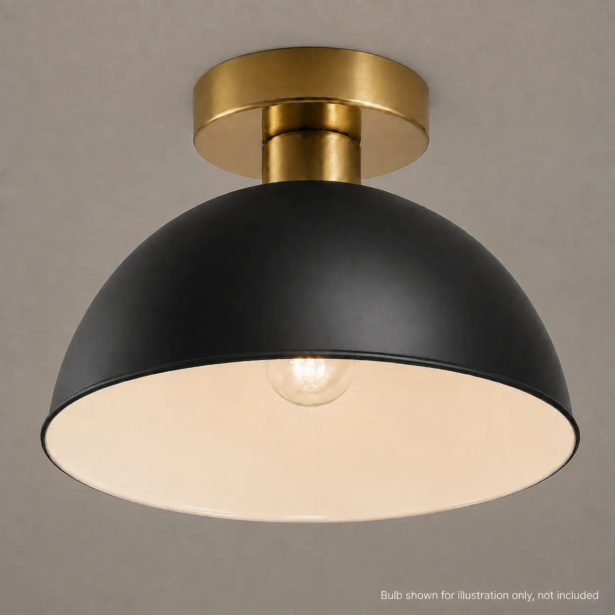 Close-up of a black dome ceiling light with a lit bulb showing the white interior finish