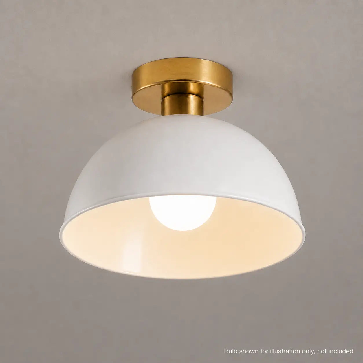 Close-up of a white dome ceiling light with a lit bulb showing the white interior finish