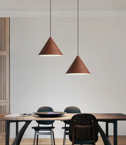 Dining room lighting with metal pendant lamps featuring wood-effect surface.