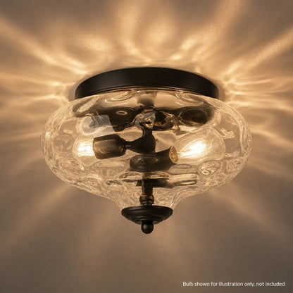 Close-up of the lit rippled glass shade creating a dappled, water-like light pattern across the ceiling.