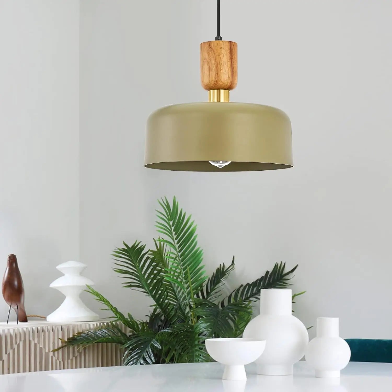 Thicket green pendant light hanging above a dining table in a modern interior.