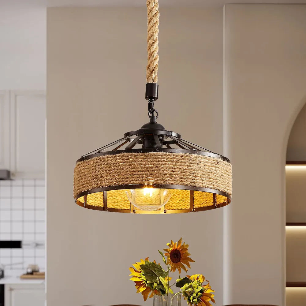 This image shows a rustic-style pendant light featuring a black metal frame with a circular design. The outer part of the light fixture is wrapped in thick natural hemp rope, giving it an industrial yet nautical look.