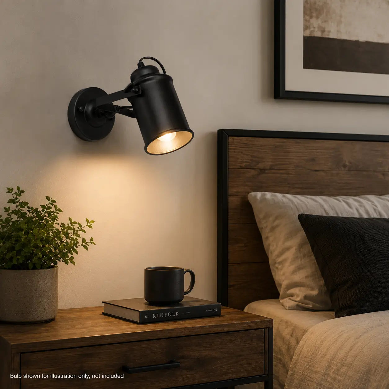 Matte black adjustable wall sconce mounted beside a wood bed and nightstand