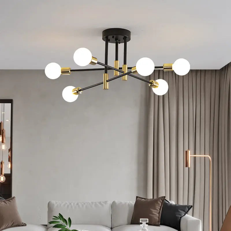 Modern black and gold ceiling light with eight arms, illuminating a stylish living room.