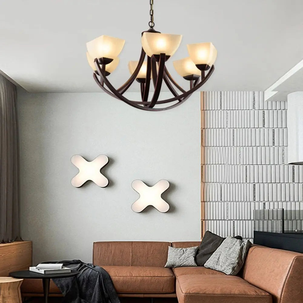 Bronze chandelier lighting fixture hanging in a modern living room.