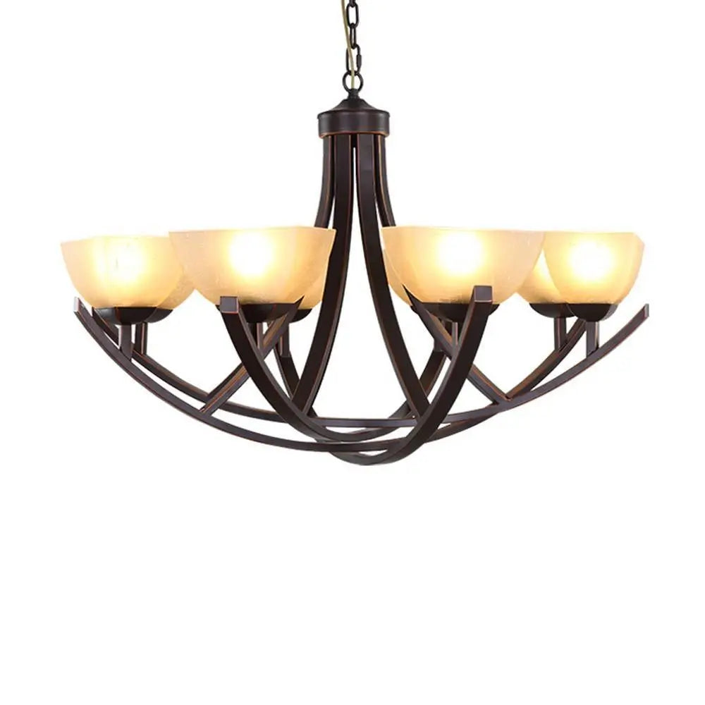 Modern rustic chandelier with iron frame and soft yellow glass lamps.