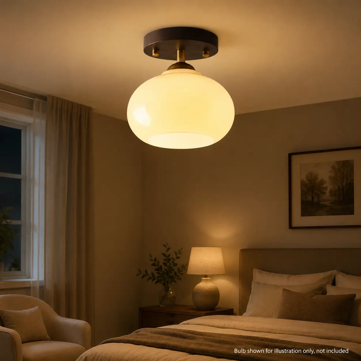 Opal glass ceiling light illuminated above a bedroom seating area at night