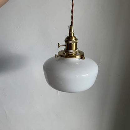 Milk glass pendant light hanging at full length showing cord and canopy