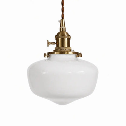 Milk glass schoolhouse pendant light with antique gold-toned hardware on a white background