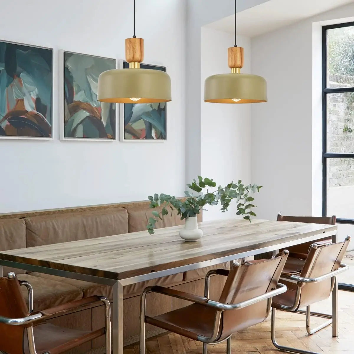 Set of two pendant lights above a wooden dining table in a contemporary setting
