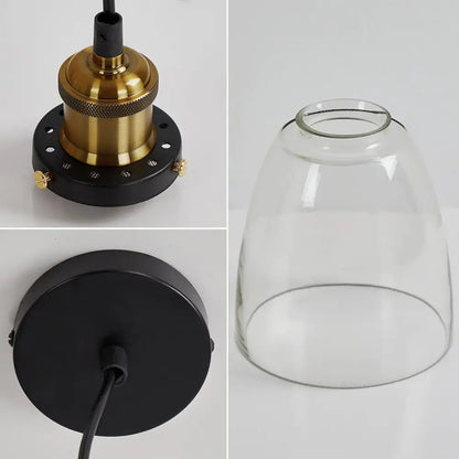 Close-up of vintage pendant light components, including the brass bulb holder, black ceiling plate, and clear glass shade.