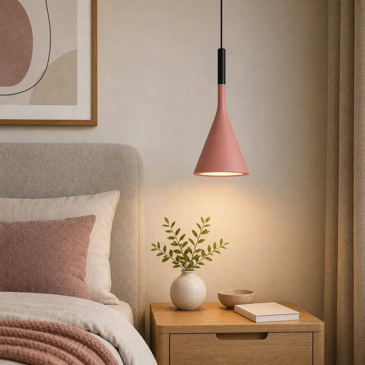 Pink cone pendant light used above a wood nightstand beside an upholstered bed.