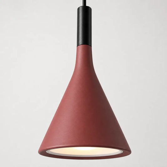 Close-up of the red metal cone shade with black upper housing and a softly illuminated opening.