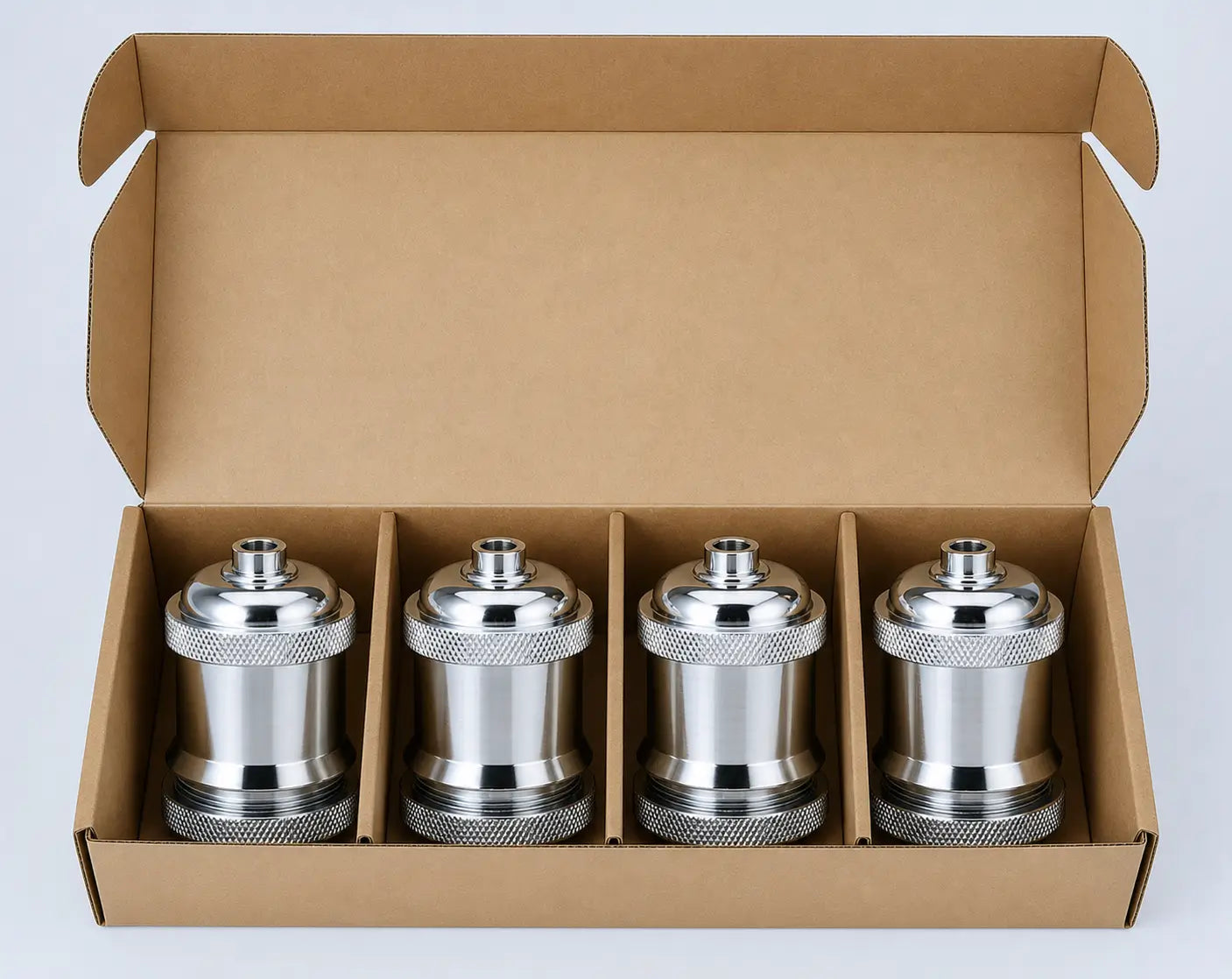 Open cardboard box containing four Silver DIY lamp sockets separated by individual cardboard dividers.