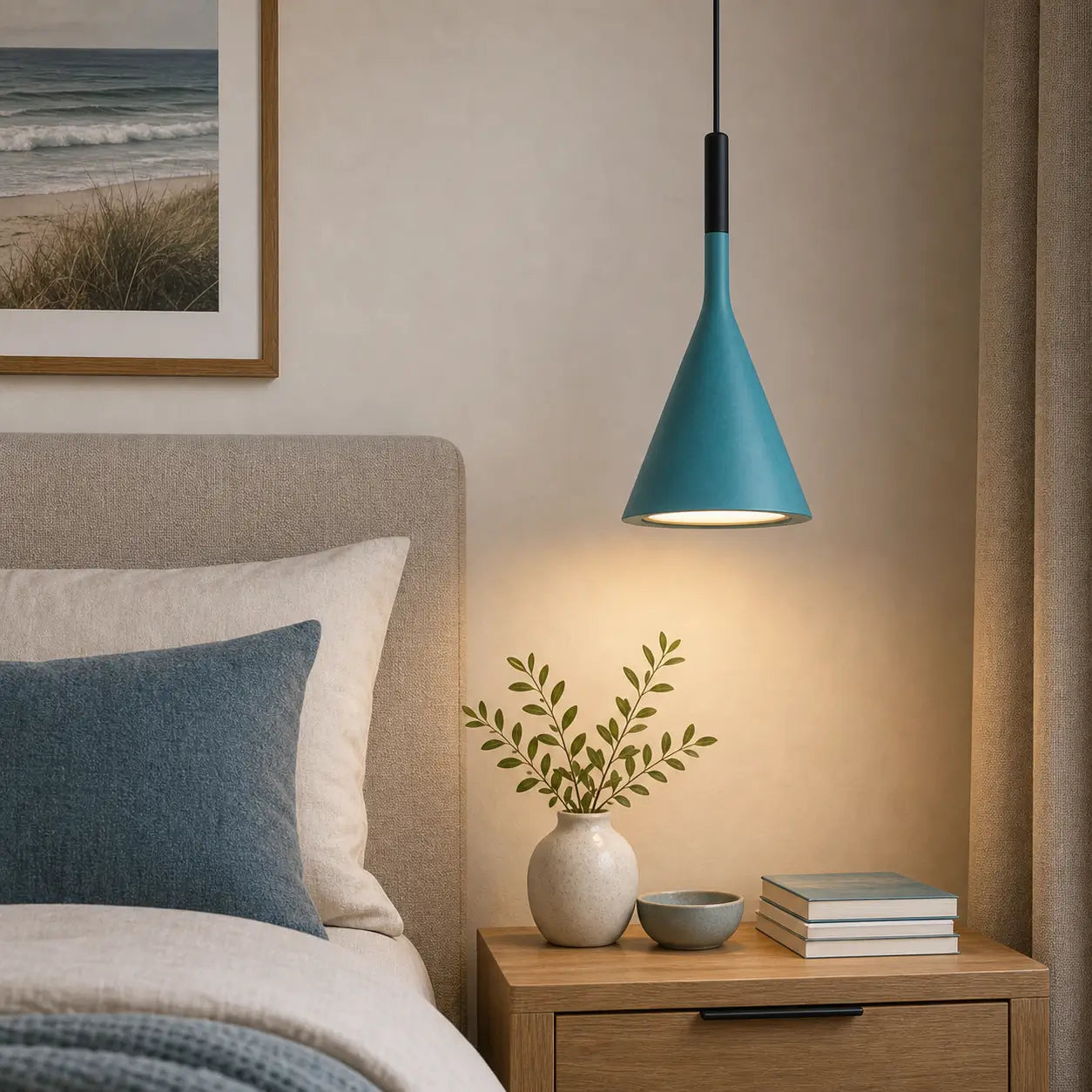 Teal cone pendant light providing downward light above a wood nightstand beside an upholstered bed.