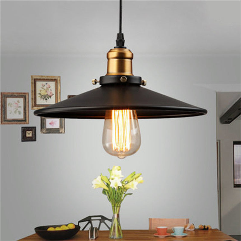 A black vintage pendant light provides lighting above the table.