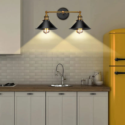 Vintage-style wall sconce installed in a modern kitchen, blending classic black and gold finishes 