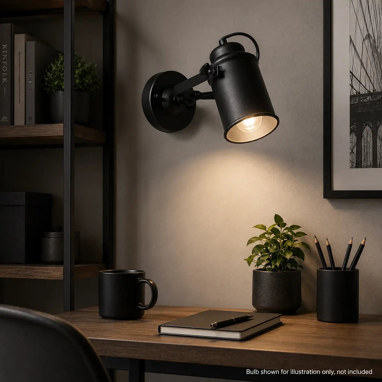Matte black wall sconce providing task light over a home office desk