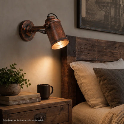 Copper wall sconce mounted above a rustic wood nightstand in a bedroom