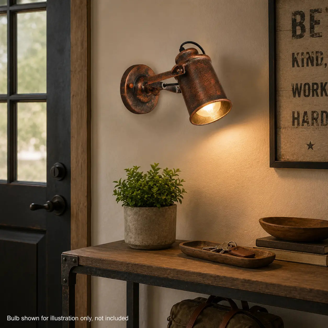 Copper wall sconce illuminating a console table in a home entryway