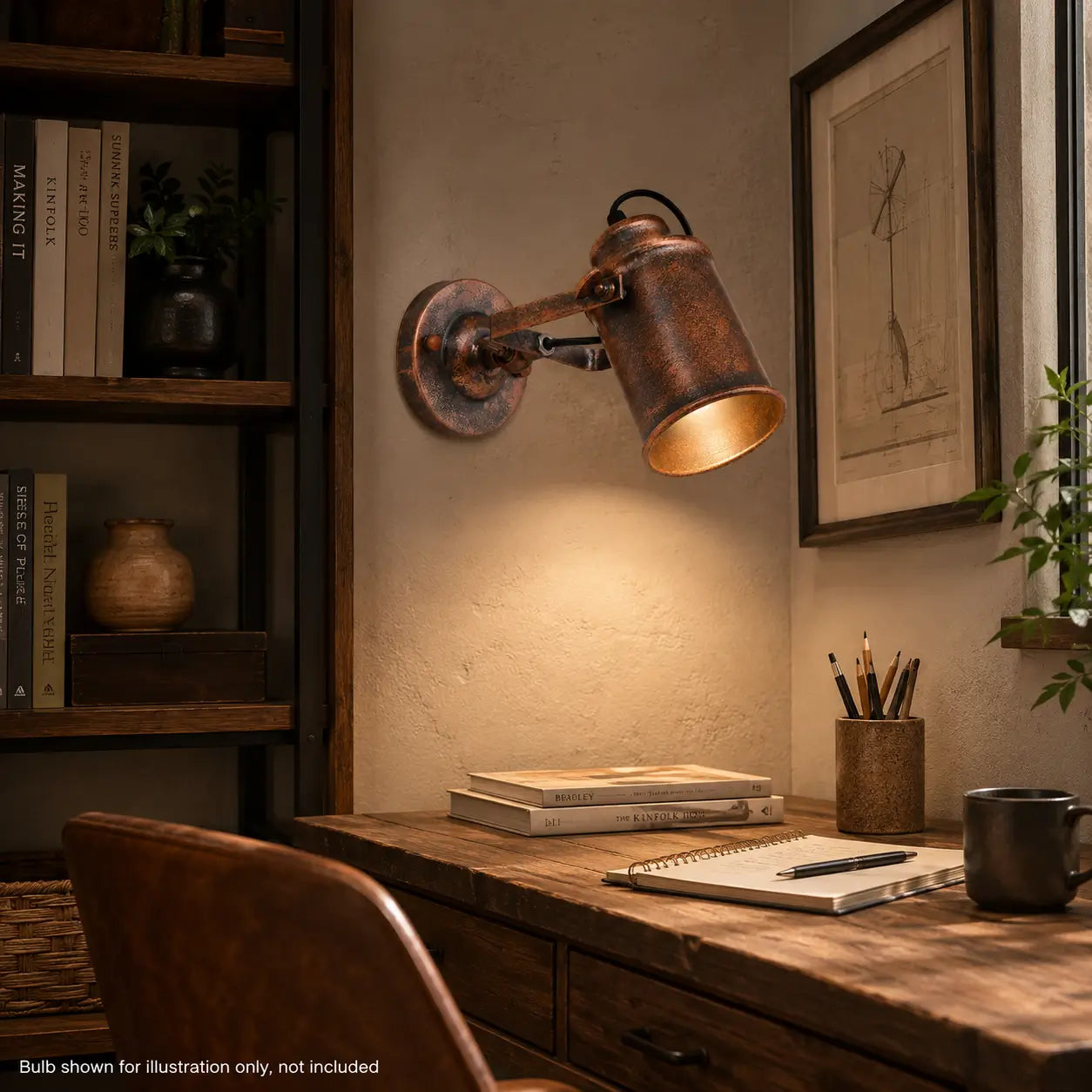 Copper wall sconce lighting a wooden desk in a home office setting