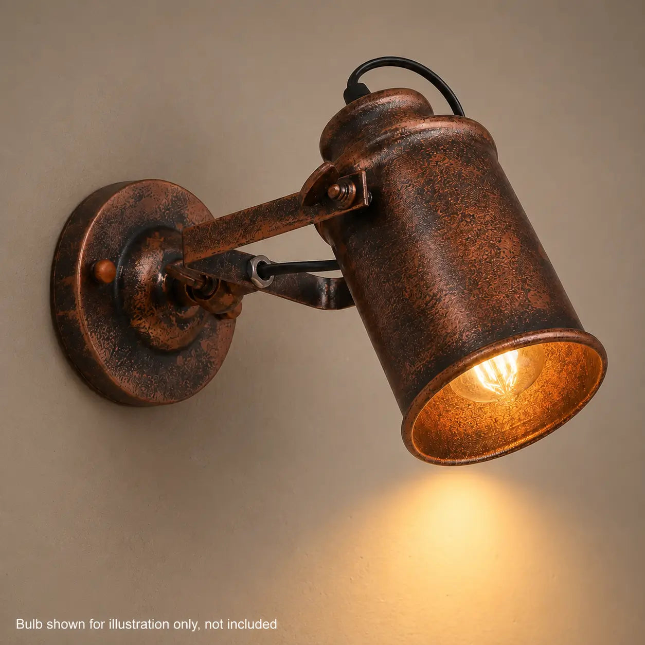 Close-up of lit copper wall sconce showing warm bulb glow inside the shade