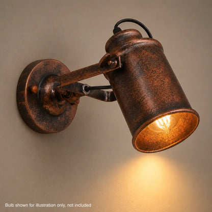 Close-up of lit copper wall sconce showing warm bulb glow inside the shade
